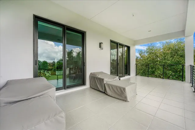 a living room with furniture and large windows