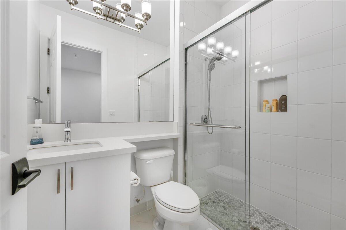 9093 Chauvet Way Boca Raton, FL 33496 - Photo 20 of 31 a bathroom with a sink a toilet and shower