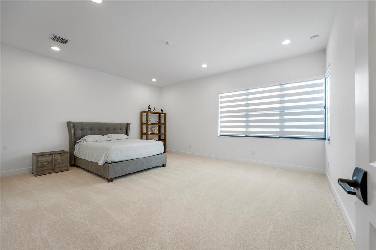 9093 Chauvet Way Boca Raton, FL 33496 - Photo 21 of 31 a bedroom with a bed and a window