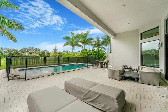 a view of a patio with couches and pool