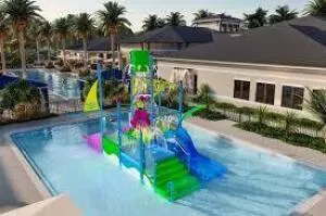 a swimming pool with outdoor seating and a garden