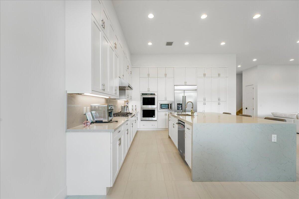 9093 Chauvet Way Boca Raton, FL 33496 - Photo 4 of 31 a large kitchen with stainless steel appliances lots of counter top space