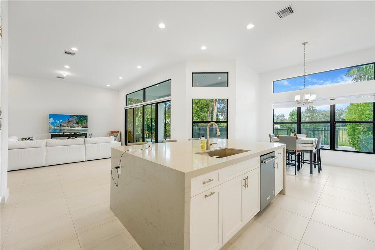 9093 Chauvet Way Boca Raton, FL 33496 - Photo 6 of 31 a large white kitchen with a large window