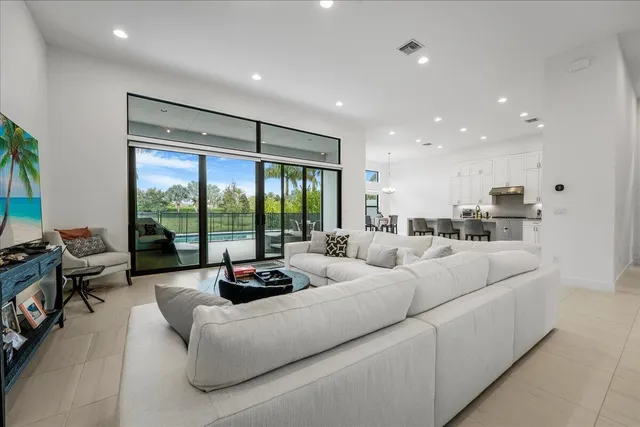 a living room with furniture and large windows