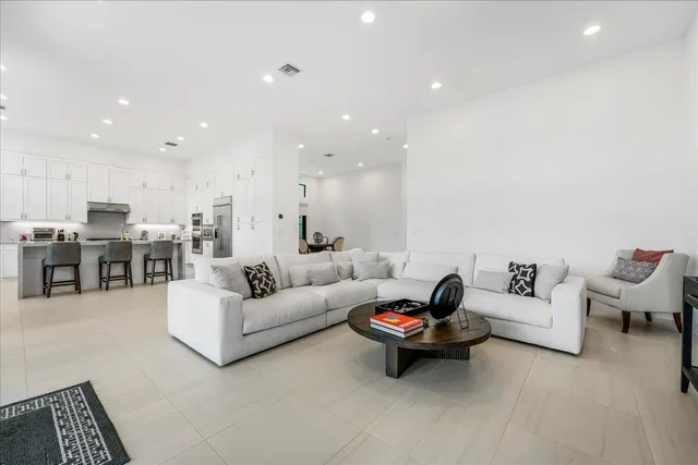a living room with furniture and kitchen view