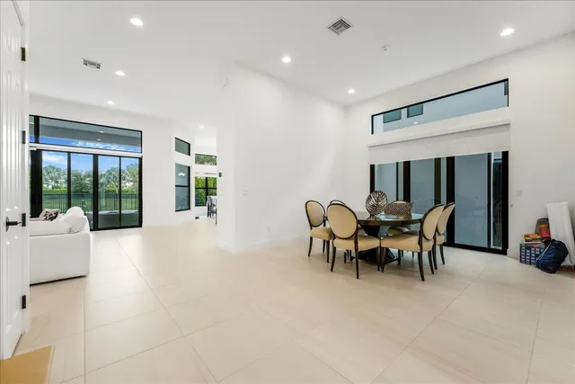 a view of a livingroom with furniture and floor to ceiling window