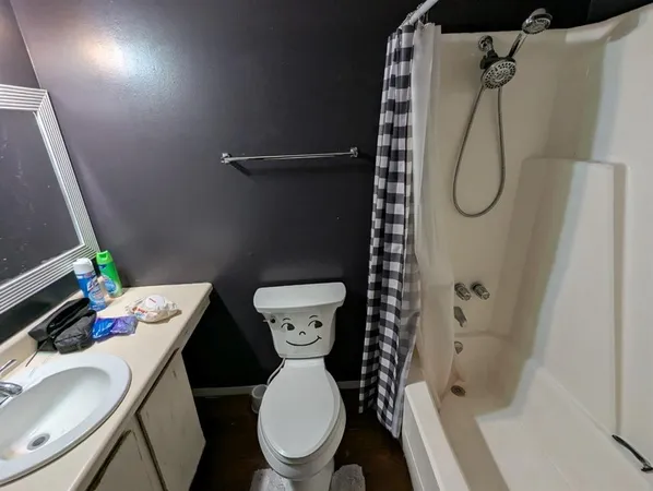 a bathroom with a toilet and shower