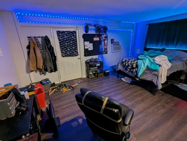 a bed room with a bed and a chair