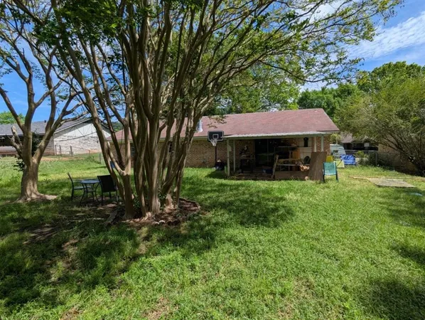 a view of house with a yard