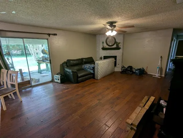 a living room with furniture window and wooden floor