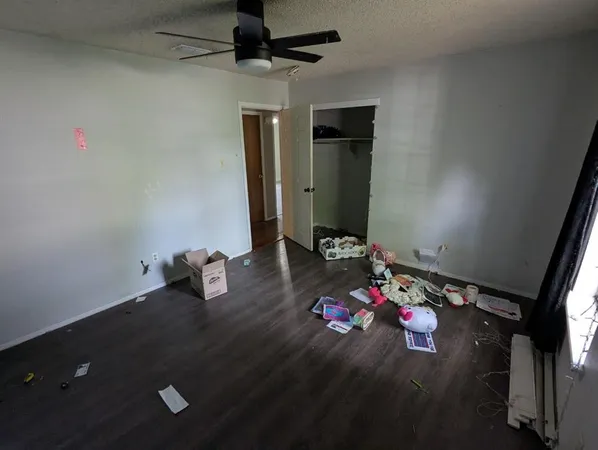 a room with a wooden floor and gym equipment