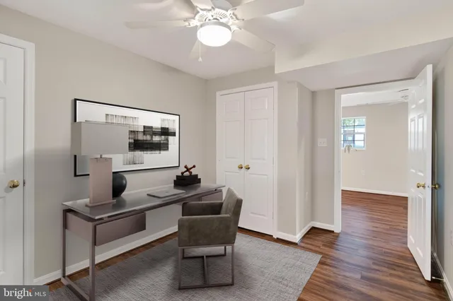 a view of a room with wooden floor and white walls