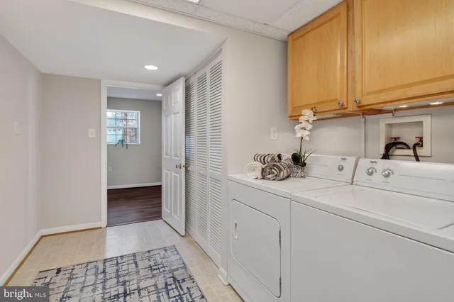 a bathroom with a sink a mirror and a potted plant
