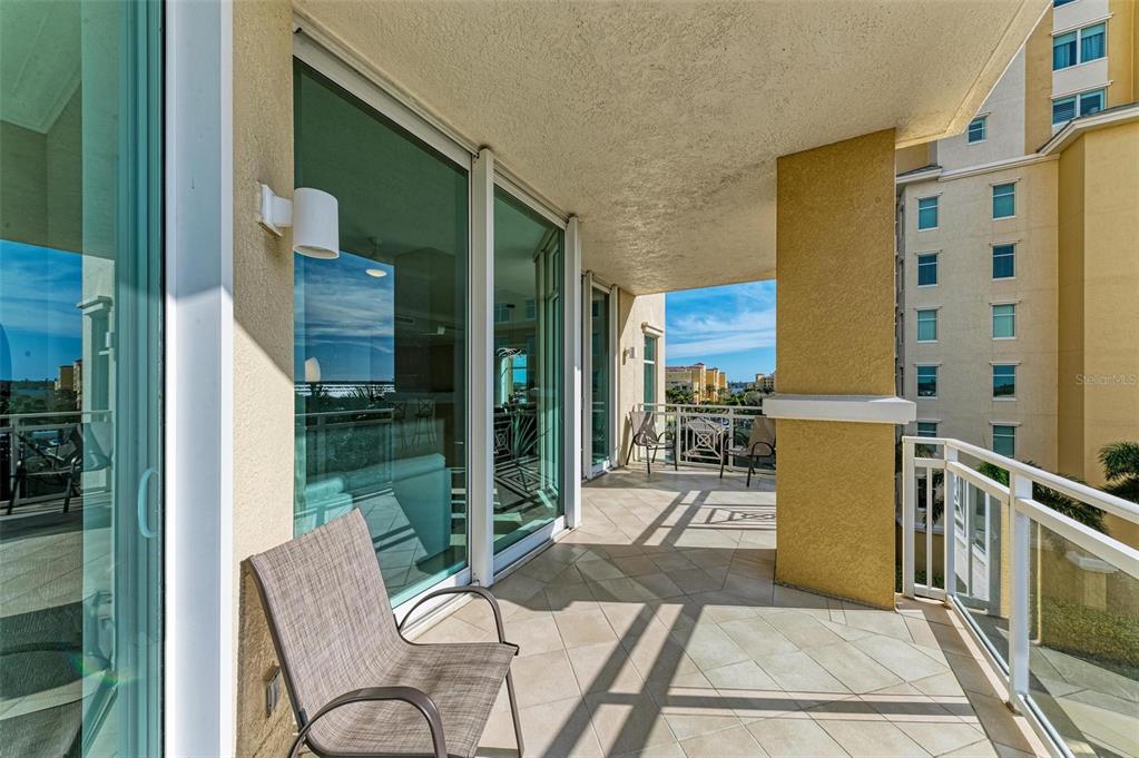 140 Riviera Dunes Way, Unit 404 Palmetto, FL 34221 - Photo 17 of 31 a balcony with table and chairs