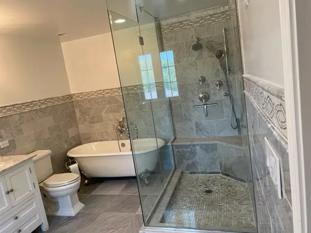 a bathroom with a toilet and a shower