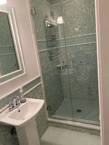 a bathroom with a shower and sink