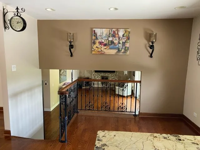 a view of entryway and hall with wooden floor