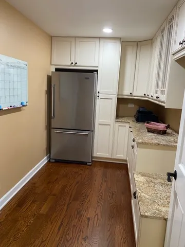 a kitchen with a refrigerator sink and cabinets