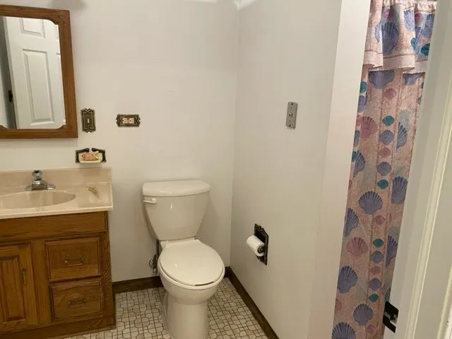 a bathroom with a toilet sink and mirror
