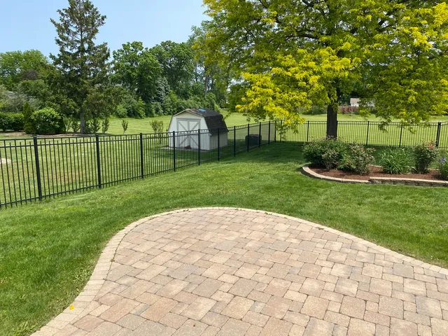 a path view of a house with a backyard