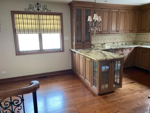 a kitchen with a stove and a wooden cabinets