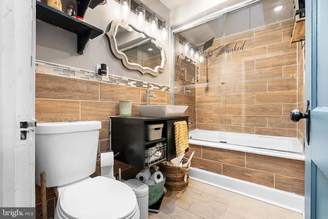 a bathroom with a sink a toilet and a bathtub