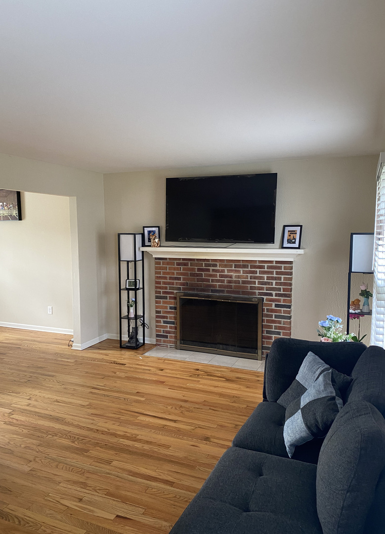 1805 Rita Avenue St. Charles, IL 60174 - Photo 11 of 17 a living room with furniture a fireplace and a flat screen tv