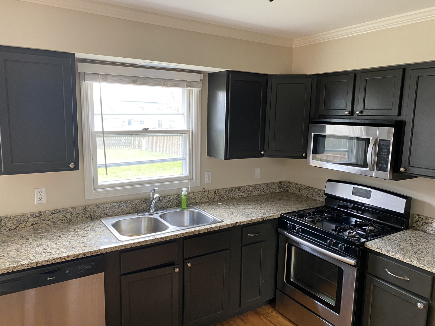 1805 Rita Avenue St. Charles, IL 60174 - Photo 8 of 17 a kitchen with granite countertop a sink cabinets and stainless steel appliances