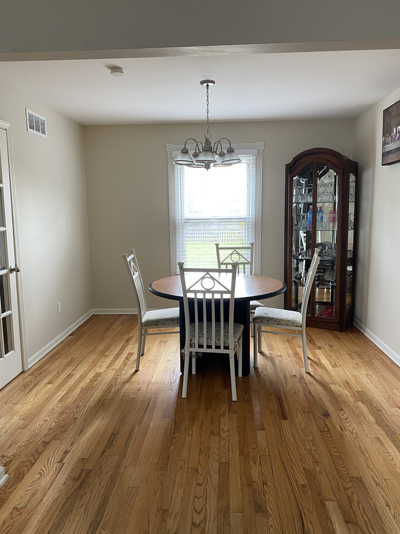 1805 Rita Avenue St. Charles, IL 60174 - Photo 10 of 17 a dining room with furniture window wooden floor