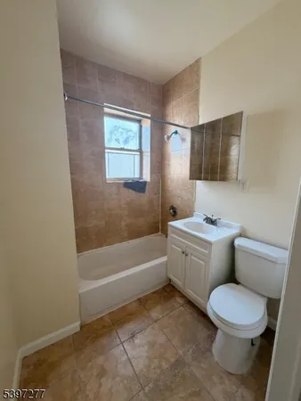 a bathroom with a toilet a sink and bathtub