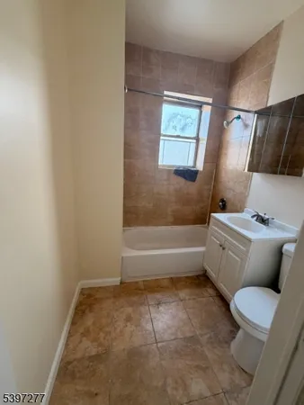 a bathroom with a toilet and a bath tub