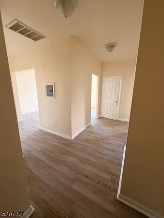a view of hallway with wooden floor