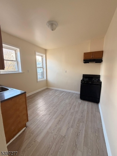 120 Bragaw Avenue, Unit 3 Newark, NJ 07112 - Photo 9 of 16 wooden floor in an empty room with a window