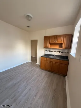 a kitchen with wooden floors and a stove top oven