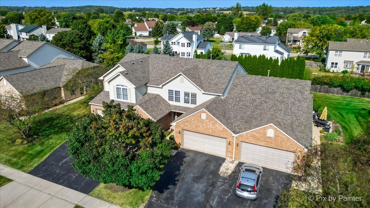 an aerial view of multiple houses with a yard