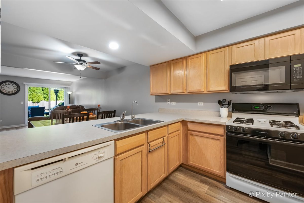 5742 Fieldstone Trail McHenry, IL 60050 - Photo 12 of 29 a kitchen with a sink stove and microwave