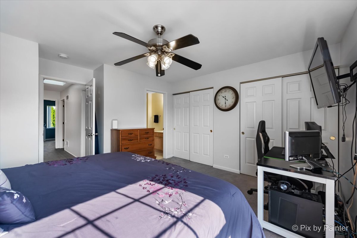 5742 Fieldstone Trail McHenry, IL 60050 - Photo 17 of 29 a bedroom with a bed and a chandelier