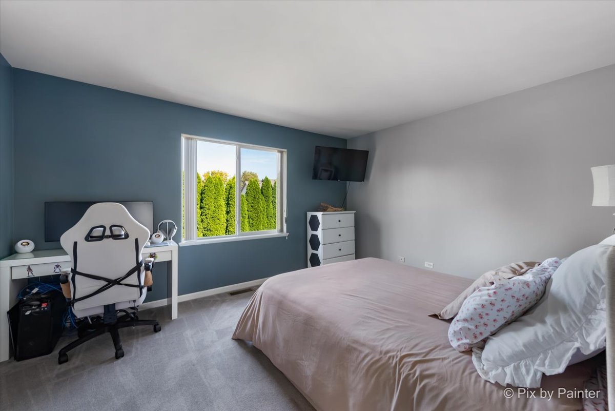 5742 Fieldstone Trail McHenry, IL 60050 - Photo 18 of 29 a bedroom with a bed chair and window