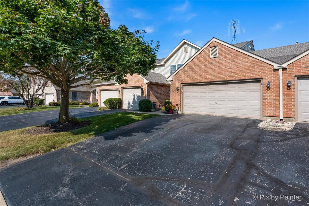 5742 Fieldstone Trail McHenry, IL 60050 - Photo 24 of 29 a front view of a house with a yard and garage