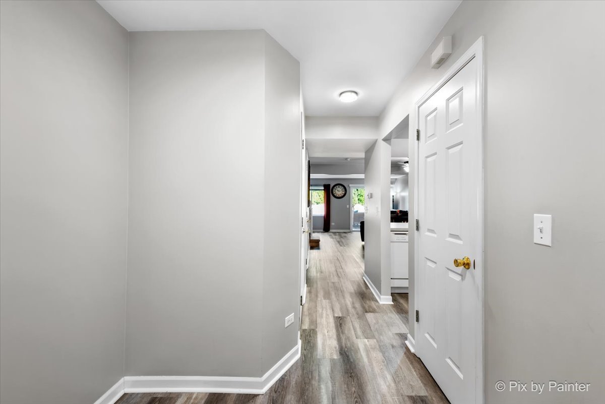 5742 Fieldstone Trail McHenry, IL 60050 - Photo 6 of 29 a view of a hallway with wooden floor