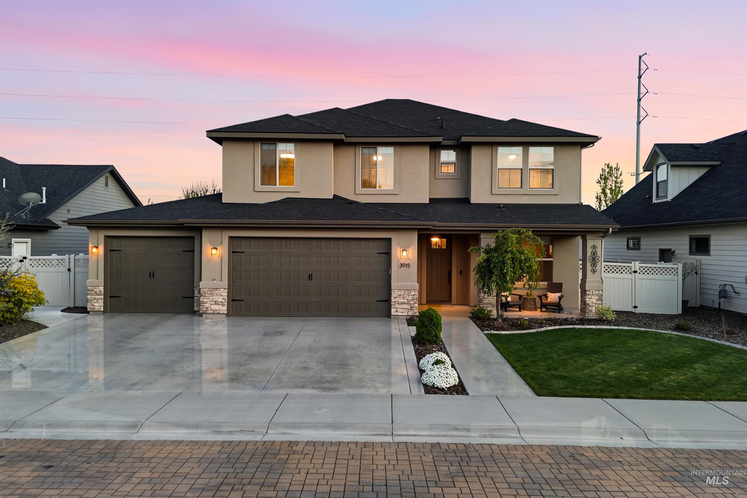 Stucco exterior with stone accents and a dark roof