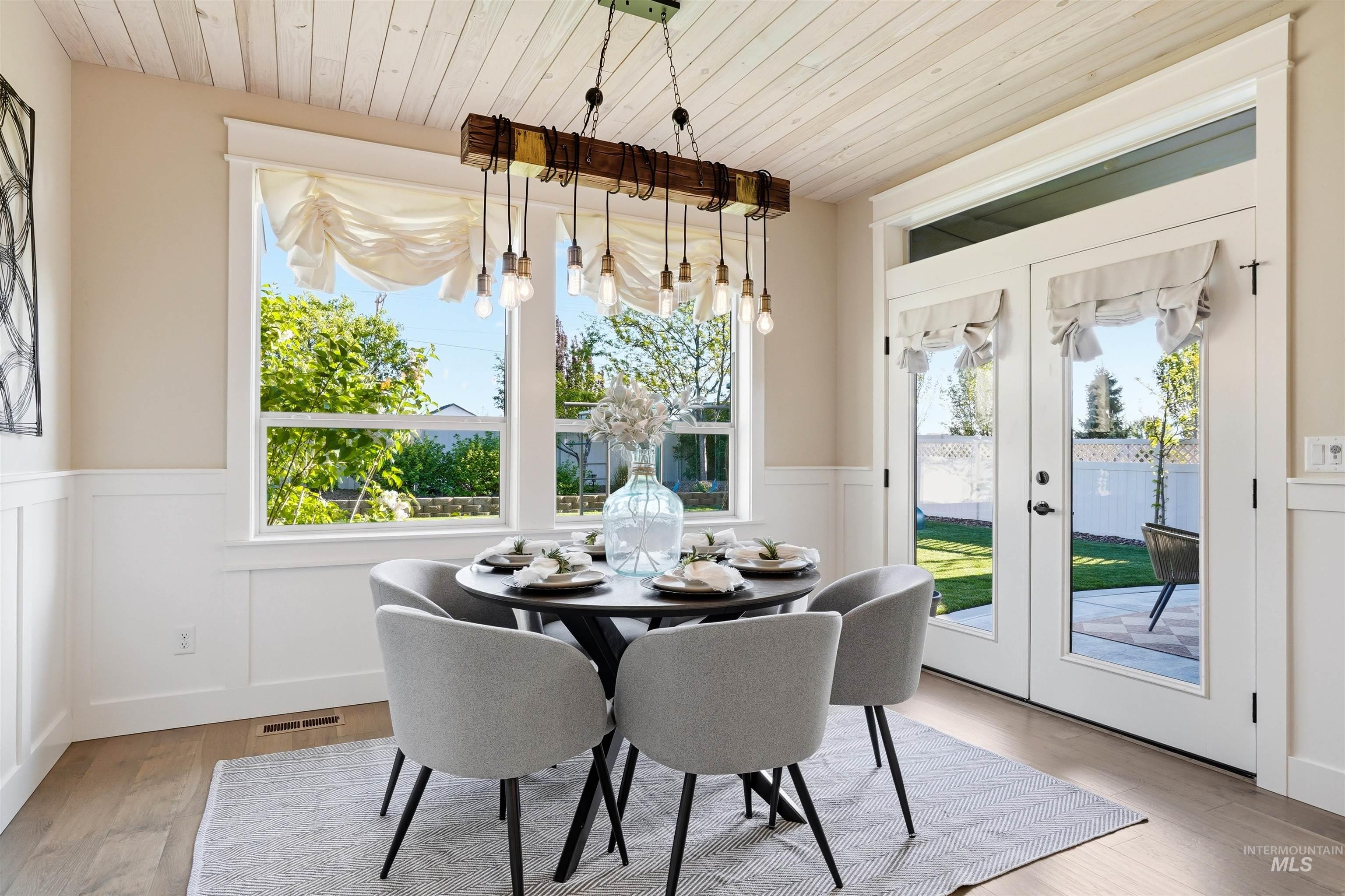 3915 West Riva Capri Street Meridian, ID 83646 - Photo 12 of 49 Dining area featuring wood-finish flooring and wainscoting