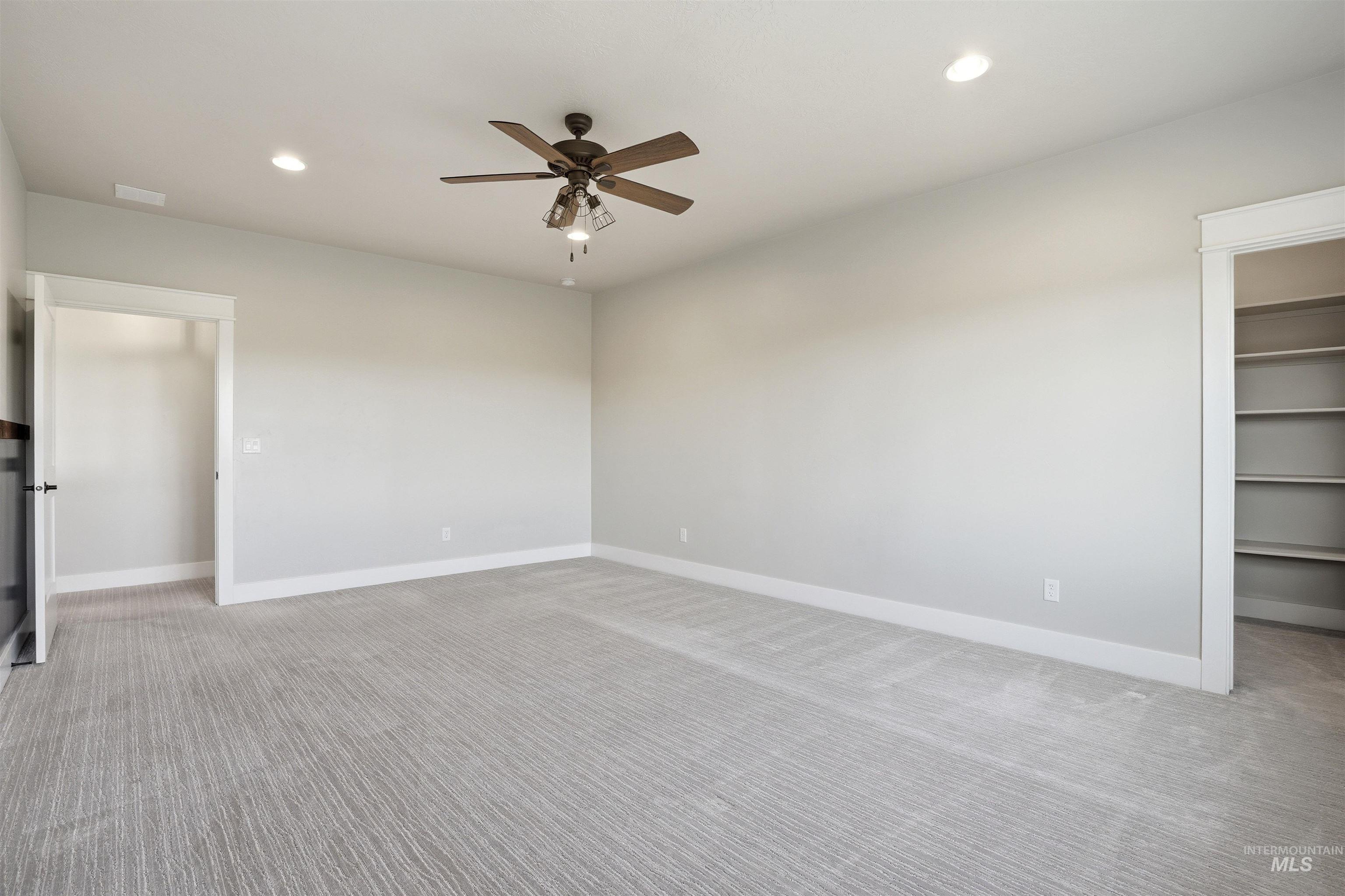 3915 West Riva Capri Street Meridian, ID 83646 - Photo 29 of 49 Spacious room with light gray walls and patterned gray carpeting
