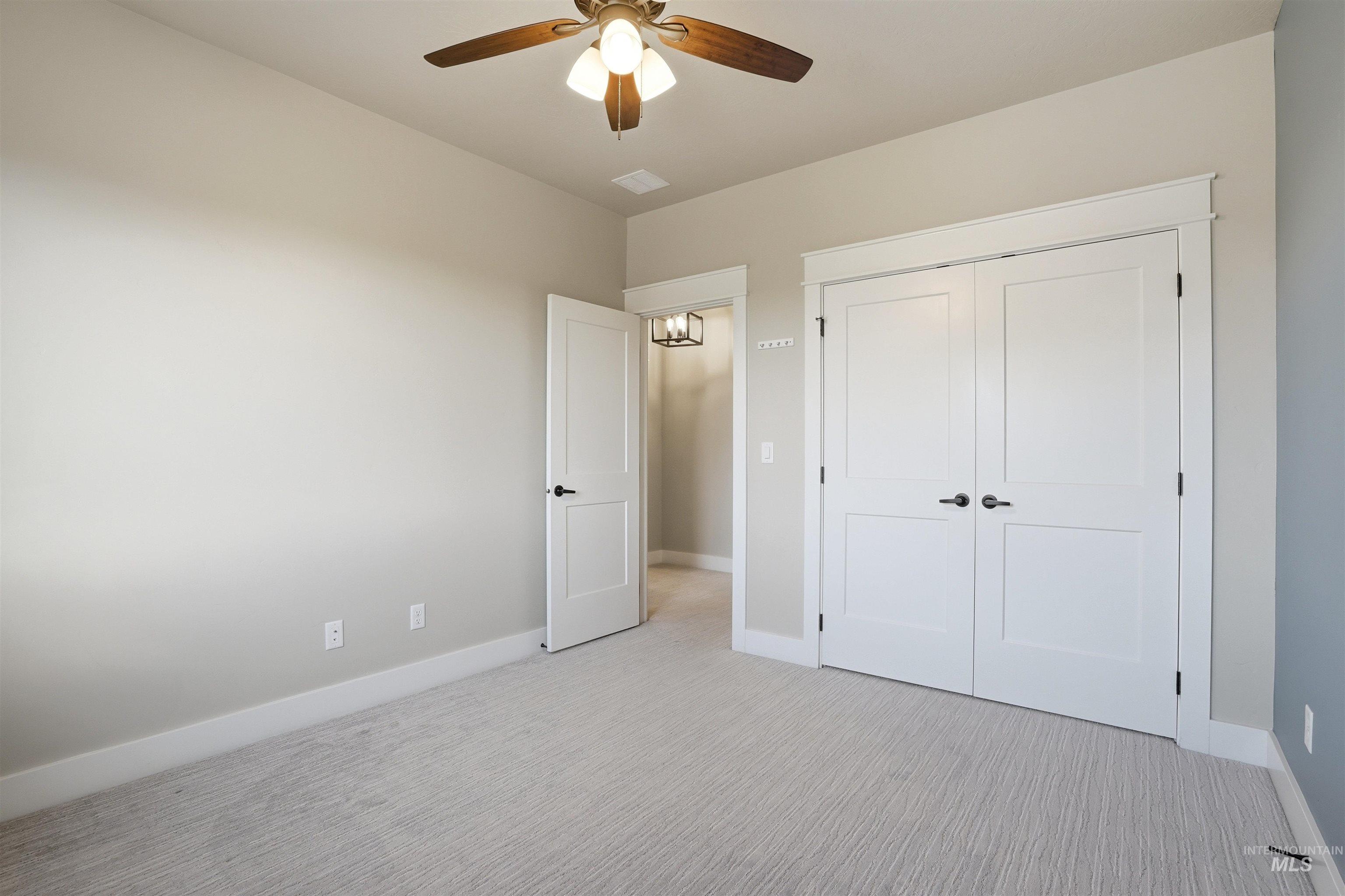 3915 West Riva Capri Street Meridian, ID 83646 - Photo 32 of 49 Neutral-toned room featuring light-colored carpeting and a ceiling fan with integrated lighting