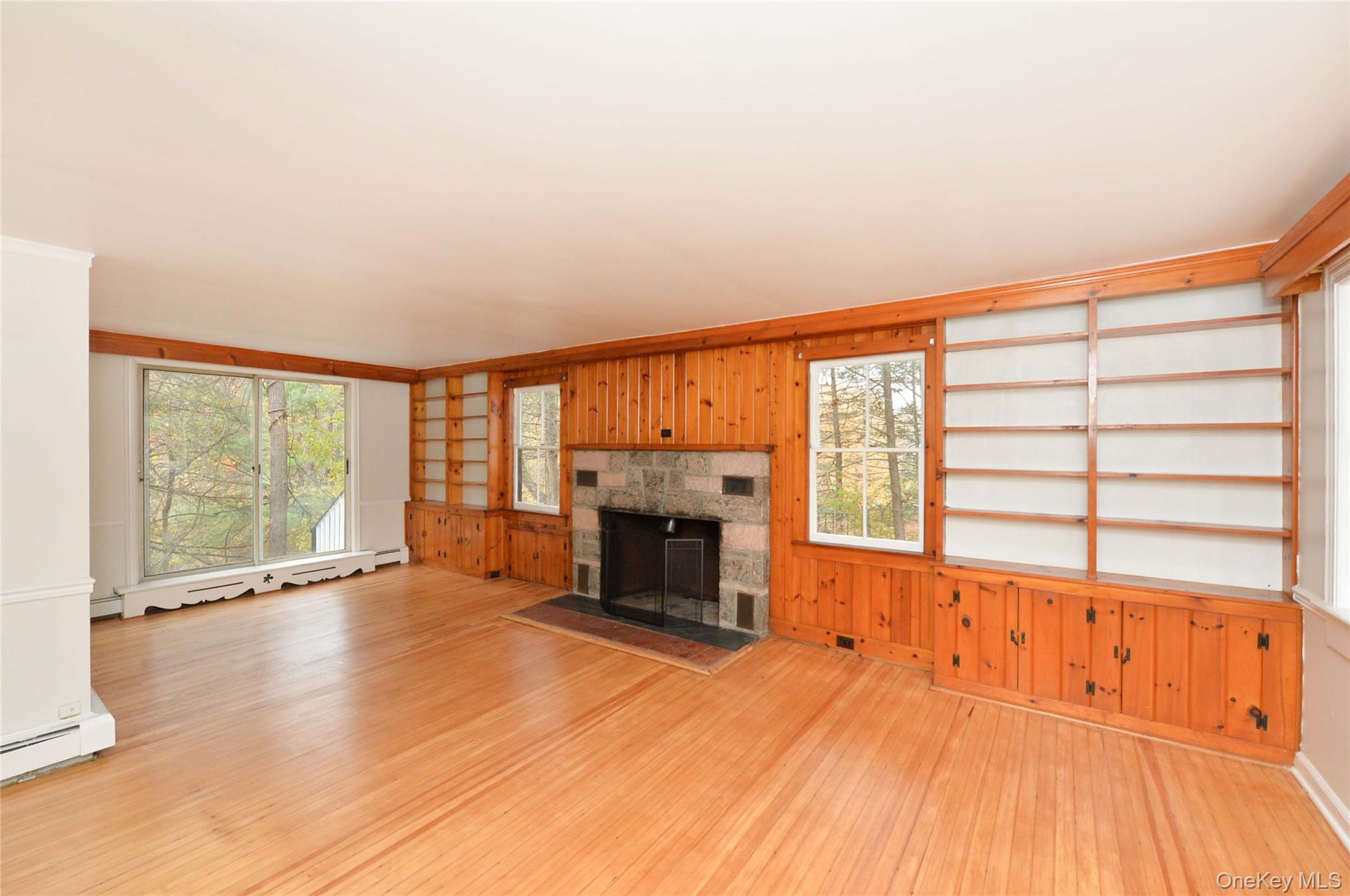 19 Johnsontown Road Sloatsburg, NY 10974 - Photo 19 of 41 wooden floor fireplace and windows in an empty room