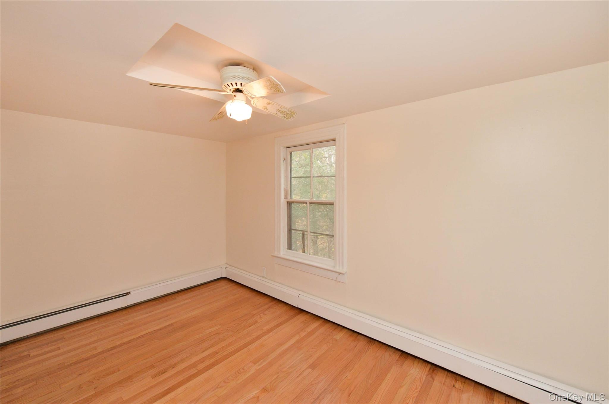 19 Johnsontown Road Sloatsburg, NY 10974 - Photo 25 of 41 an empty room with wooden floor fan and windows