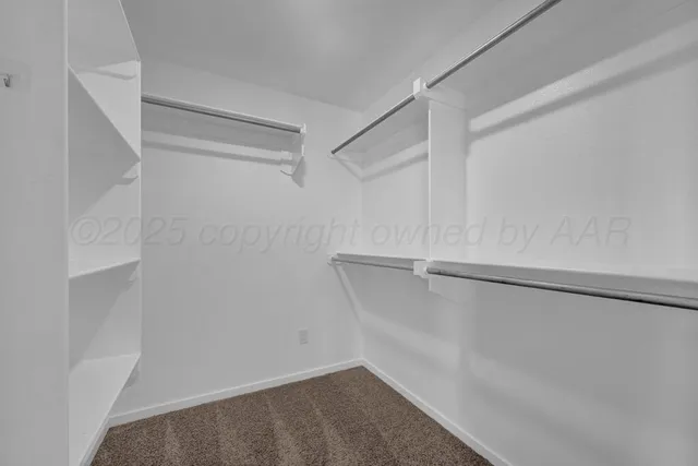 an empty room with closet and windows