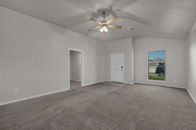 a view of an empty room with a fan