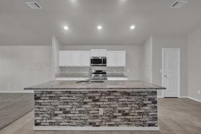 a view of a kitchen counter top space and cabinets
