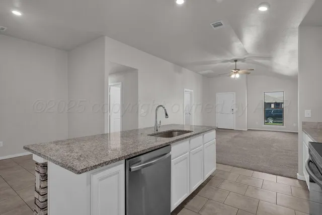 a kitchen with a sink and cabinets
